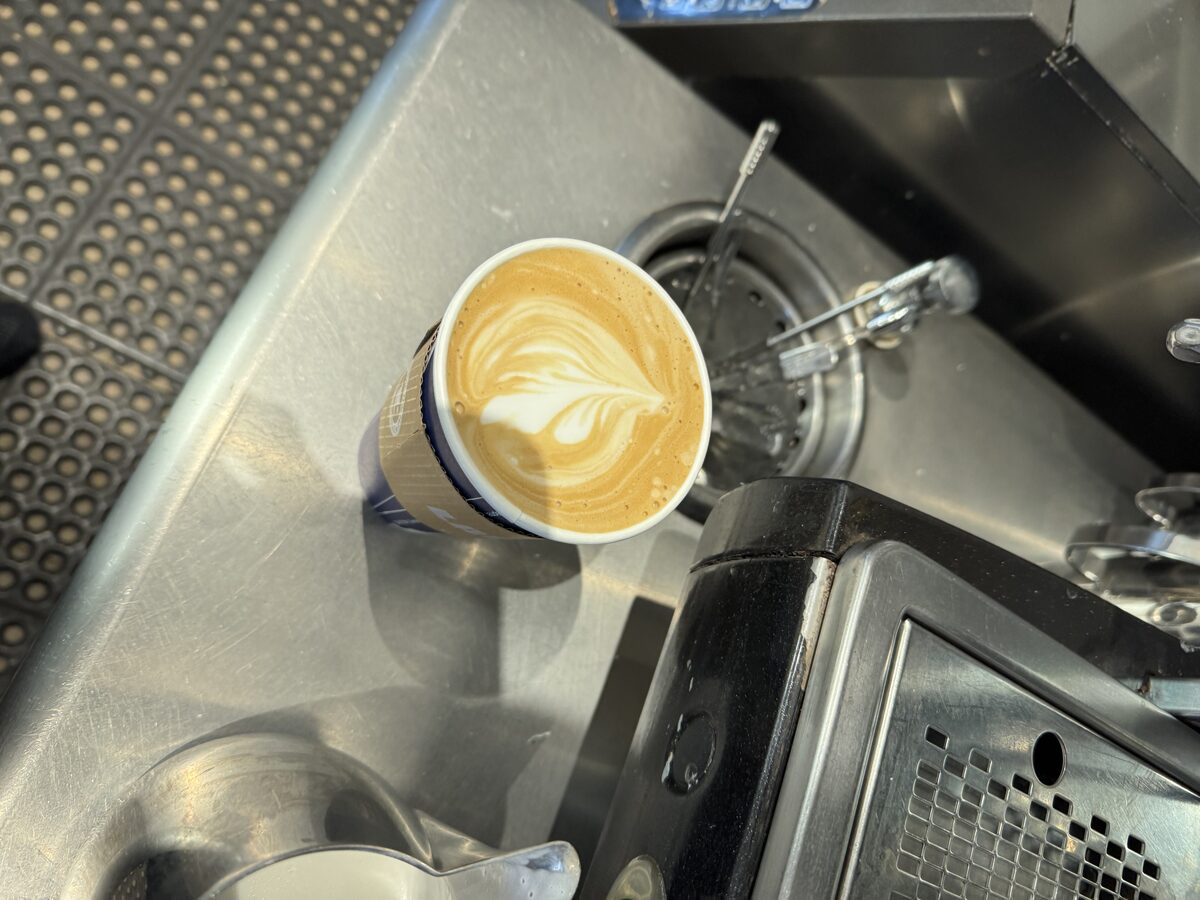Heart pour in a to-go cup by the espresso machine
