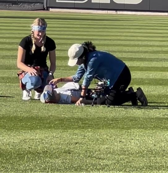Trial participants administering Narcan to a test dummy next to the landed drone