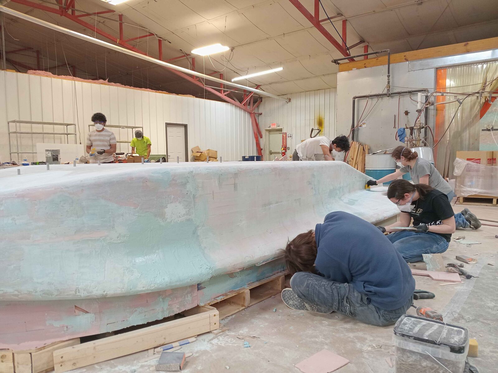 Team block sanding bondo on the plug
