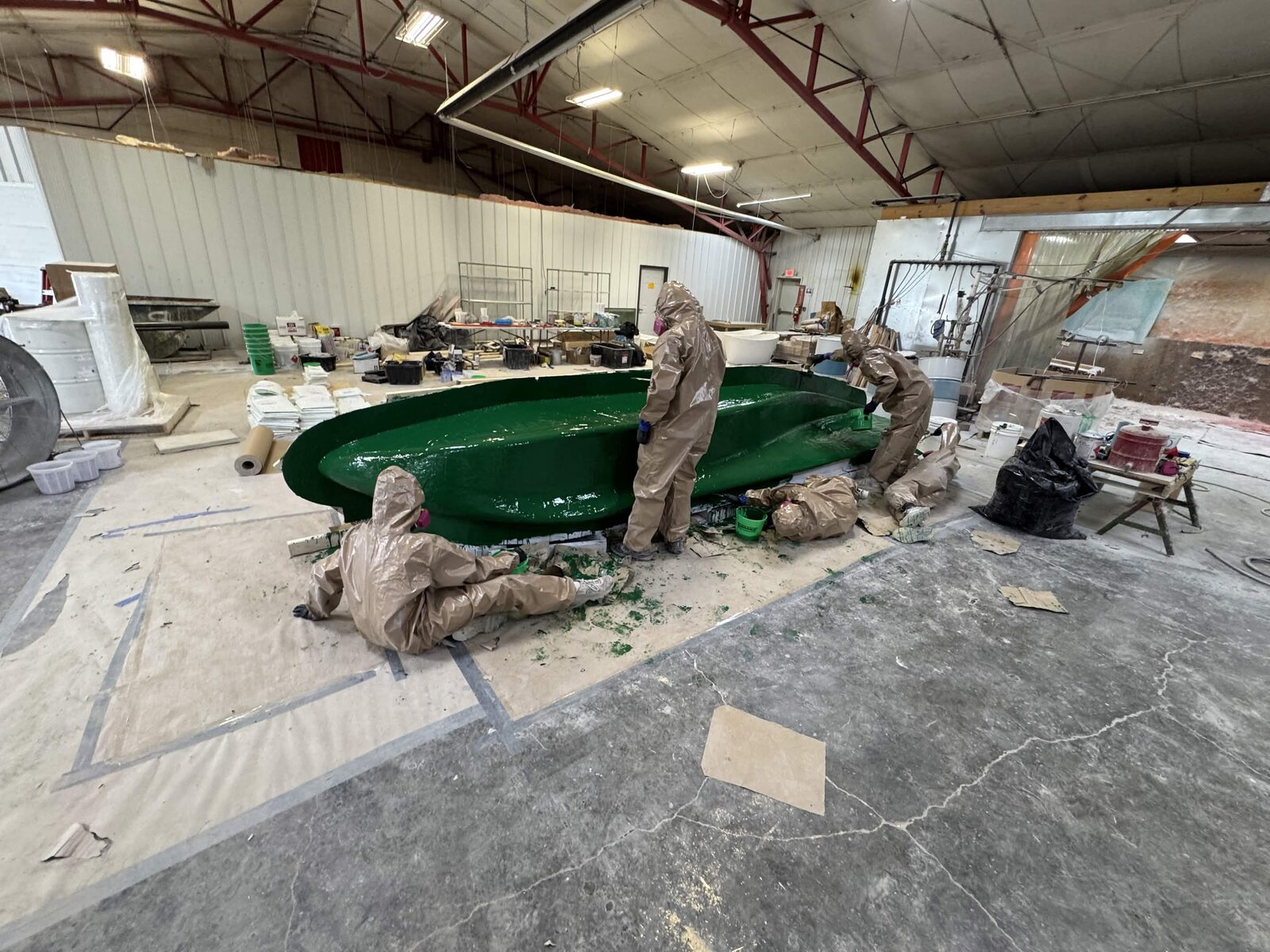 Team applying green tooling gel coat over the plug