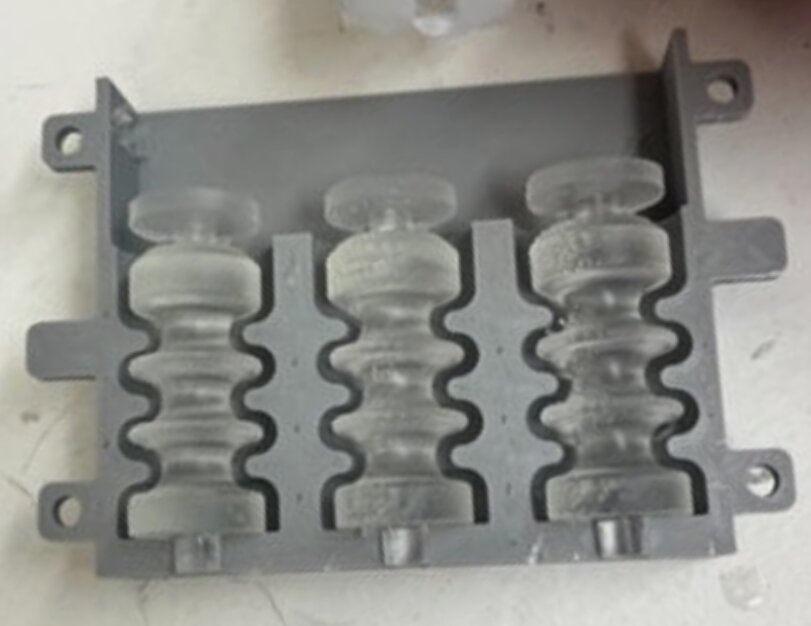 Three-cavity mold with cured silicone bellows inside